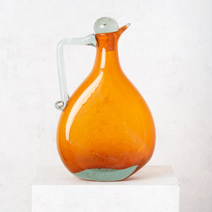 Orange crushed blown glass jug with clear stopper