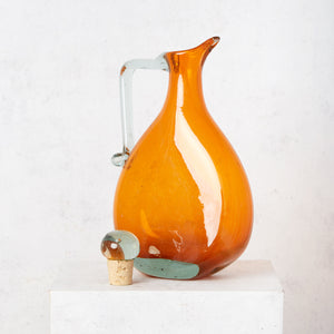 Orange crushed blown glass jug with clear stopper