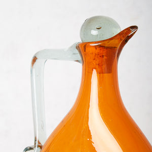 Orange crushed blown glass jug with clear stopper