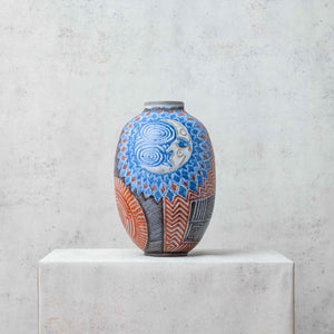 Clay eclipse vase painted in blue and terracotta tones