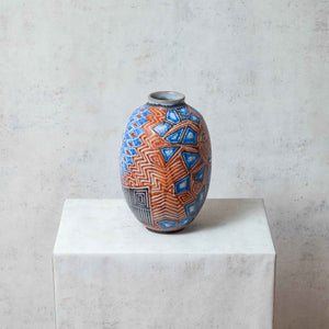 Clay eclipse vase painted in blue and terracotta tones