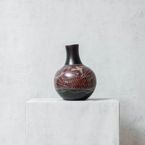Small burnished clay vase in brown and black tones