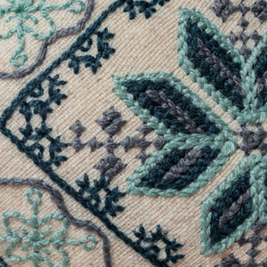 Small Mazahua flower cushion in raw and blue tones