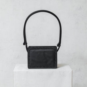 "Mini City" black leather and jargon bag.