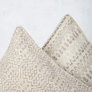 White and taupe wool cushion