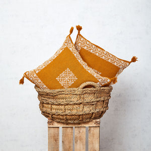 Cushion with tassels and mustard border